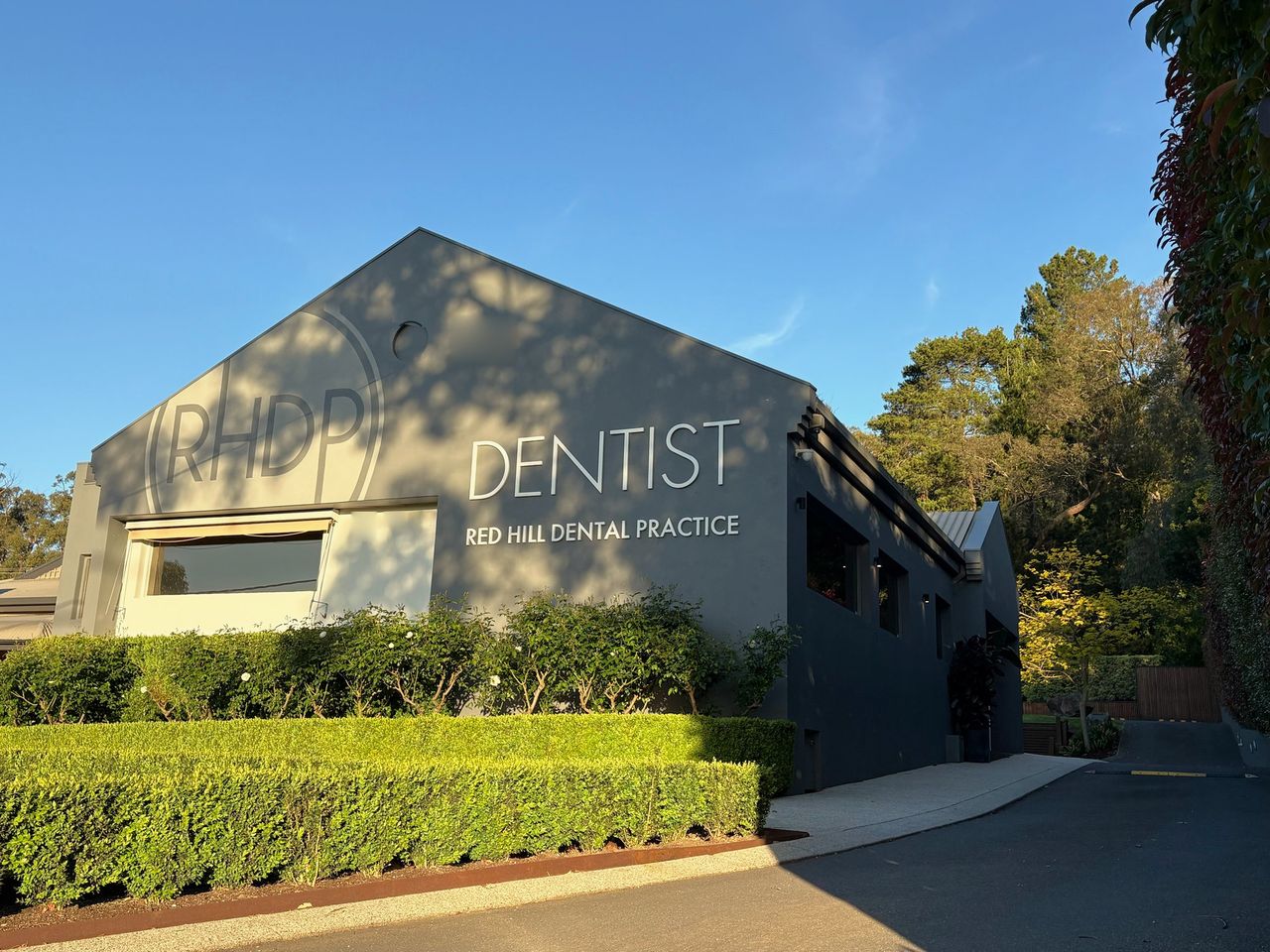 The front of Red Hill Dental Practice, with its DENTIST sign on the gable wall