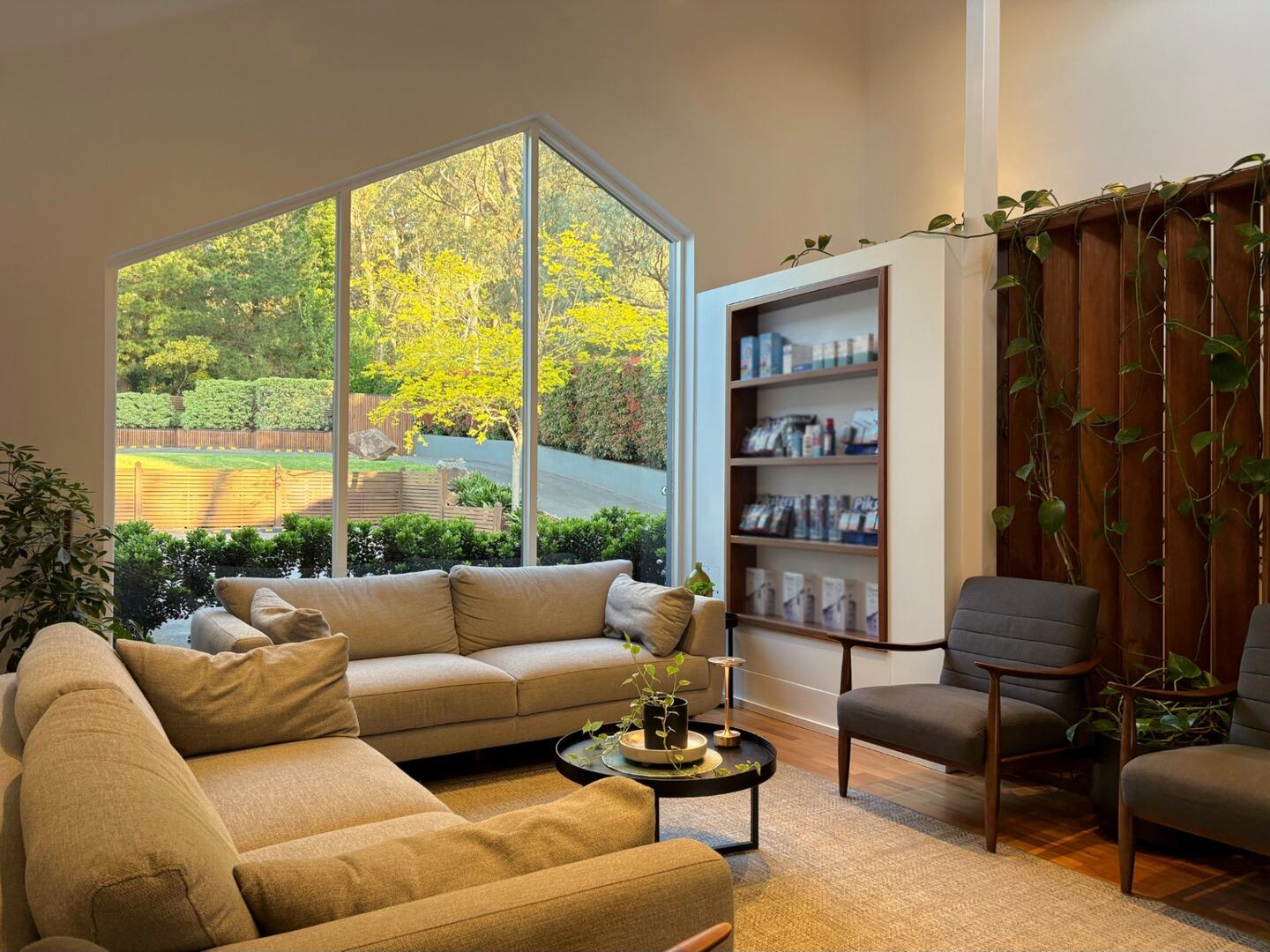 The waiting room at Red Hill Dental Practice, with a tall gabled window looking out to the garden