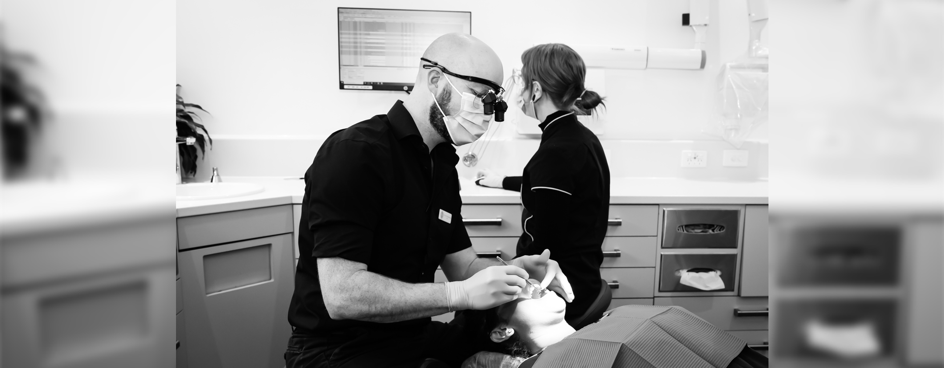 Dr. Chris Wooldridge and Dental Hygienist treating a patient