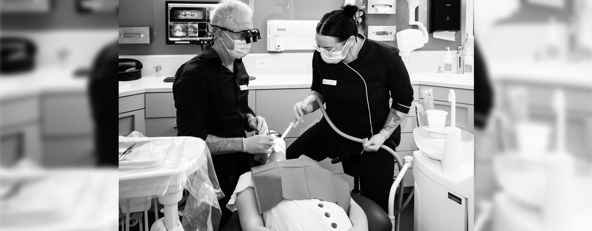 Dr. Paul Gleeson and Dental Hygienist treting a patinet